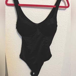 Black corset-like body suit